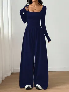 Elegant navy blue long sleeve jumpsuit featuring a square neck and flowy wide legs