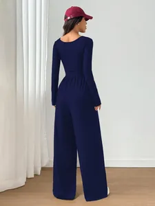 Detailed back view of a slim-fit navy blue long-sleeved wide-leg jumpsuit for women