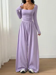 Detail view of elegant lavender square neck long sleeve wide leg jumpsuit with waist pleats