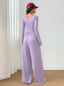 Back view of a chic lavender long sleeve jumpsuit featuring elegant wide-leg pants design