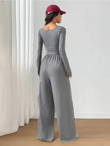 Rear view of a stylish grey long-sleeve wide-leg jumpsuit featuring a slim fit silhouette.