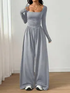 Full length view of grey square neck long sleeve wide leg jumpsuit shown on model