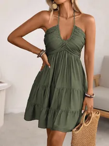 Detail view of olive green halter neck dress with tiered ruffle hem and V-neckline
