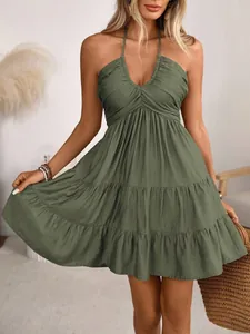 Detailed close-up showing the tiered ruffle hem of this elegant sage green halter neck mini dress.