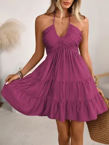 Detail of purple V-neck halter dress with ruffled hem and vacation-style tiered skirt.
