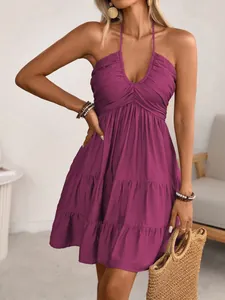 Detail view of stylish purple halter neck dress with tiered ruffles and V-neckline