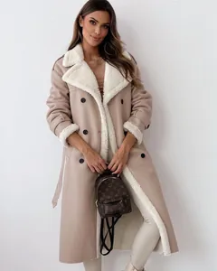 Full body view of a stylish beige shearling lapel coat worn by a model in a studio setting.