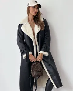 Detail view of stylish black faux leather coat with white shearling lapel for winter