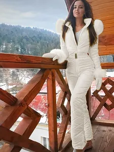 Stylish white waterproof one-piece ski suit for women with quilted design and fur trim