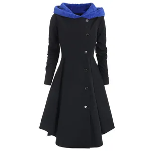 Detail of women's black long hooded coat with blue faux fur lining and asymmetrical buttons