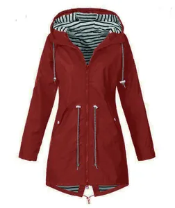 Detail view of red hooded raincoat with black and white striped lining and drawstring