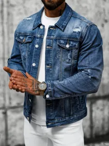 Close-up of a men's slim-fit distressed blue denim jacket with ripped details.