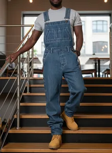 Full-body view of men's loose fit straight leg denim overalls in classic blue wash