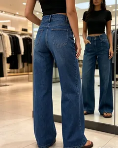 Back view of stylish high-waisted wide-leg blue denim jeans in a modern clothing boutique
