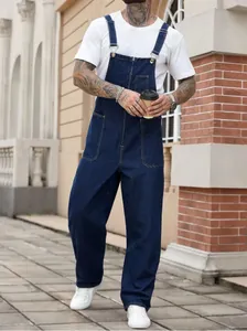Premium men's dark blue denim overalls high street workwear style lifestyle shot