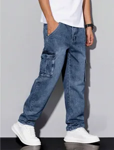 Full body view of men's straight leg cargo denim pants with side flap pockets in washed blue