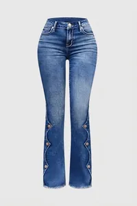 Vue détaillée d'un jean flare bleu avec des boutons décoratifs et un bord festonné.