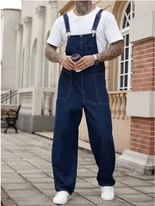 Men's dark blue denim workwear overalls with front zipper pocket in urban street setting