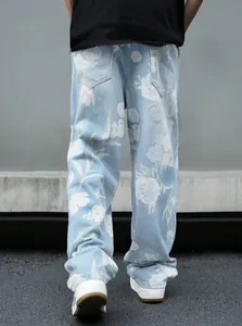 Vista posteriore di jeans oversize in denim azzurro da uomo con stampa floreale di rose.