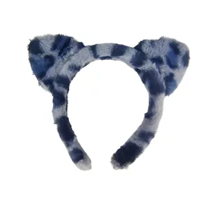 Detail view of a blue and white leopard print plush cat ear headband for makeup