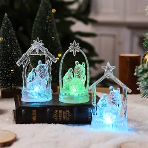 Detail of three crystal-style nativity scene LED night lights glowing on a vintage book