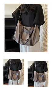 Large retro canvas tote bag with brown leather straps shown on model for travel