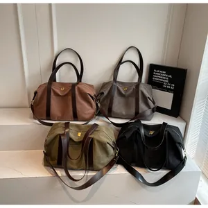 Large capacity vintage canvas travel bags in four colors shown on white steps for display