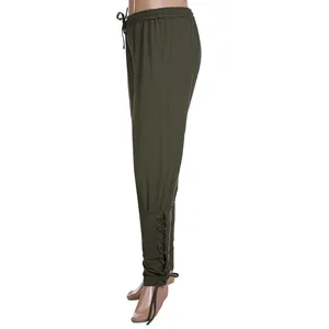 Detail view of army green medieval renaissance pants featuring adjustable lace-up leg cuffs.