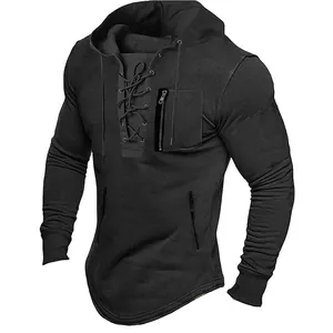 Close-up of men's lace-up hoodie with front pocket and drawstring hood detail.