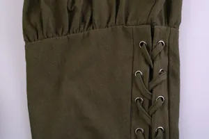 Close-up of medieval cotton linen pants showing lace-up detail and silver metal grommets.