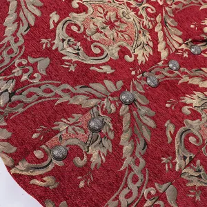 Close-up of red jacquard fabric with damask pattern and decorative vintage metal buttons.