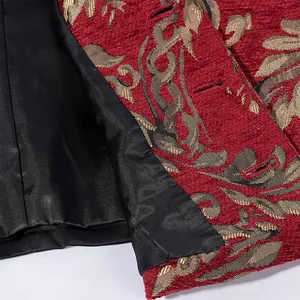 Macro detail view showing red leaf pattern jacquard fabric and smooth black lining of a vest.