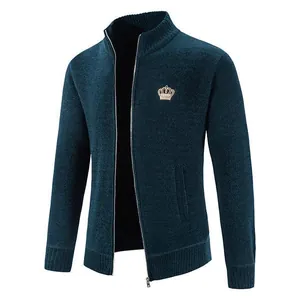 Detailed view of men's blue knitted zip-up cardigan with golden crown embroidery.