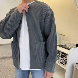 Detail showing the thick ribbed knit texture and zipper of this men's grey cardigan