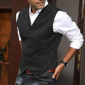 Close-up detail of a men's dark grey herringbone tweed vest with elegant lapel collar