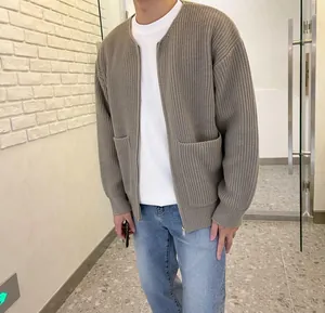 Close-up of a men's khaki ribbed knit zip cardigan featuring a relaxed oversized fit