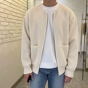 Close-up of men's loose casual ribbed knit cardigan in cream with front pockets