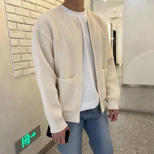 Detail of cream-colored knit cardigan for men featuring thick texture and zip closure