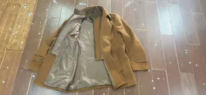 Detailed view of men's wool coat interior lining and stylish double collar design