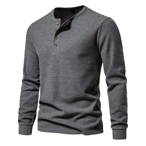 Detailed view of the waffle knit texture on this grey four-button men's Henley shirt