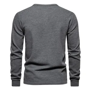 Back view of a gray waffle knit long sleeve shirt for men with ribbed cuffs.