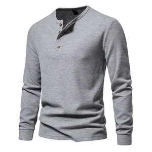 Close-up detail of the waffle knit texture and four-button collar on this grey Henley shirt