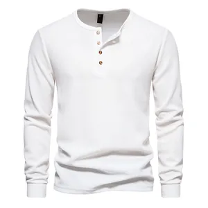 High-quality detail of men's white waffle knit Henley T-shirt featuring a four-button placket.