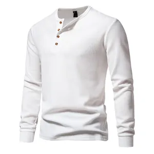 Detailed view of men's white long sleeve waffle knit henley shirt with four buttons