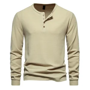 Close-up view of a men's long-sleeve waffle knit Henley shirt with four-button detail.