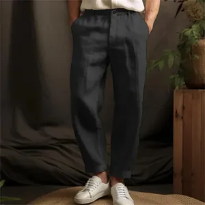 Detail showing the straight-leg fit and linen texture of dark grey men's trousers