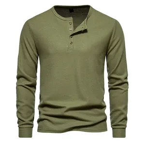 Detailed view of men's olive green long-sleeved waffle knit Henley shirt with four buttons