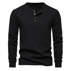 Detail view of the black waffle knit texture on this 4-button long sleeve henley shirt