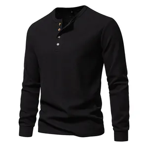 Macro view of black waffle texture and four-button placket on men's long sleeve Henley shirt