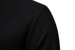 Close-up macro view of the black waffle knit fabric texture on a men's long sleeve Henley shirt
